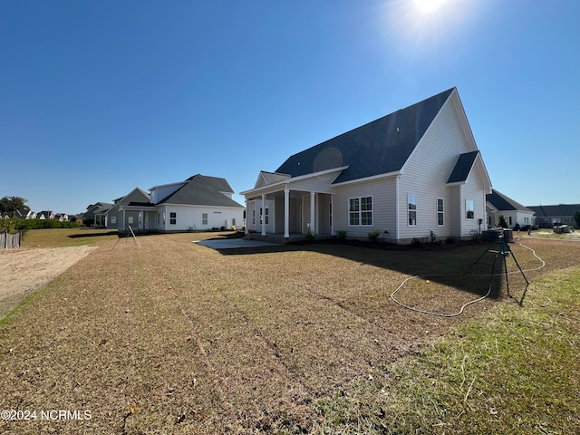 rear view of property with a yard