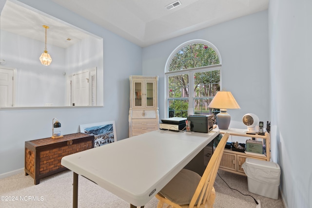 office space featuring baseboards, visible vents, and light colored carpet