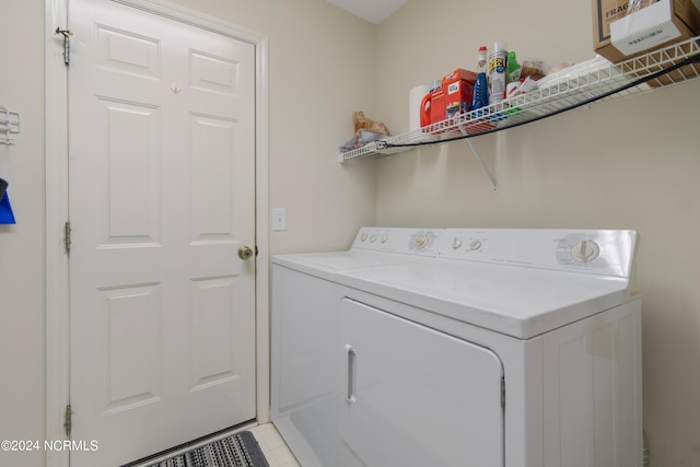 clothes washing area featuring laundry area and washing machine and clothes dryer