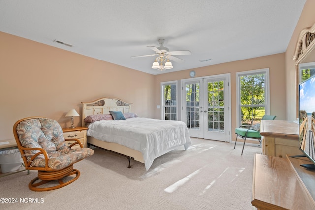 bedroom featuring light carpet, access to exterior, visible vents, and french doors