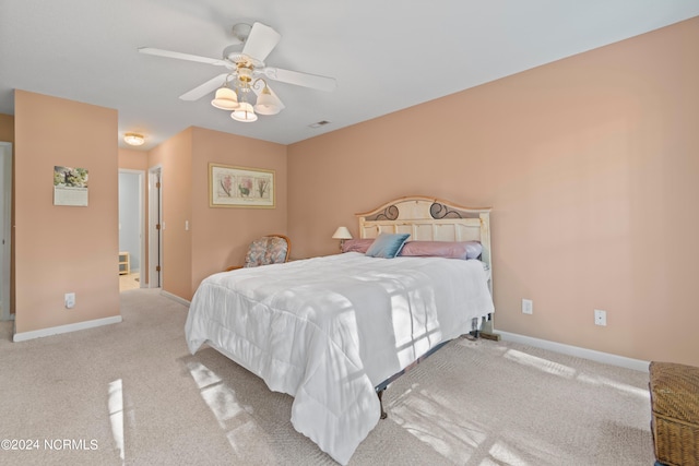 bedroom featuring light colored carpet, ceiling fan, and baseboards