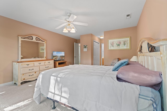 carpeted bedroom featuring a closet, visible vents, ceiling fan, and baseboards