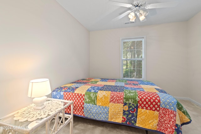 carpeted bedroom featuring a ceiling fan and visible vents