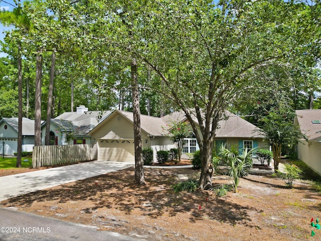 ranch-style house featuring concrete driveway and an attached garage