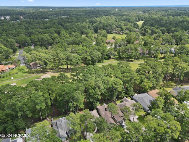 drone / aerial view featuring a residential view and a forest view