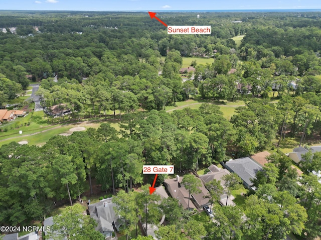 drone / aerial view featuring a forest view and a residential view