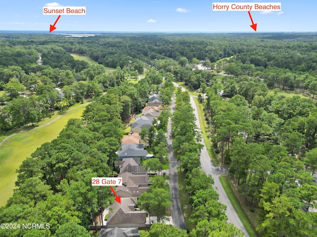 aerial view featuring a forest view and a residential view