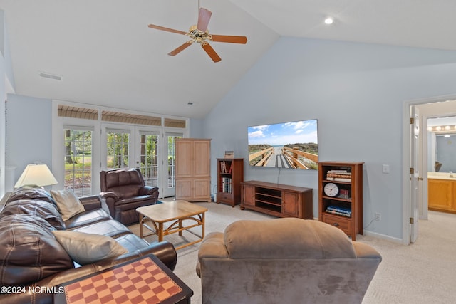 living room with light colored carpet, visible vents, ceiling fan, high vaulted ceiling, and baseboards