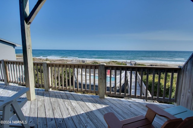 wooden terrace with a beach view and a water view