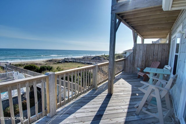 deck featuring a view of the beach and a water view