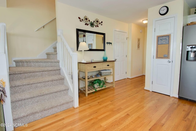 stairs featuring hardwood / wood-style floors