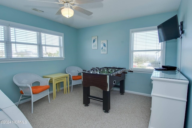 rec room with light colored carpet and ceiling fan