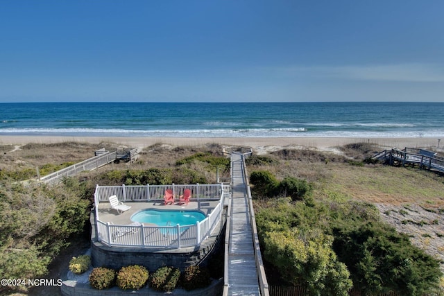 aerial view with a water view and a beach view