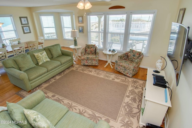 living room with hardwood / wood-style flooring, a wealth of natural light, and ceiling fan