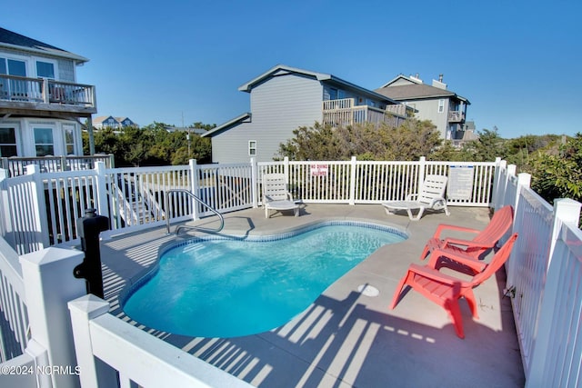 view of swimming pool with a patio area