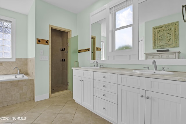 bathroom featuring tile patterned floors, vanity, and separate shower and tub