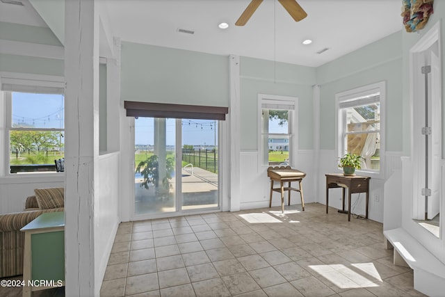 sunroom / solarium featuring ceiling fan