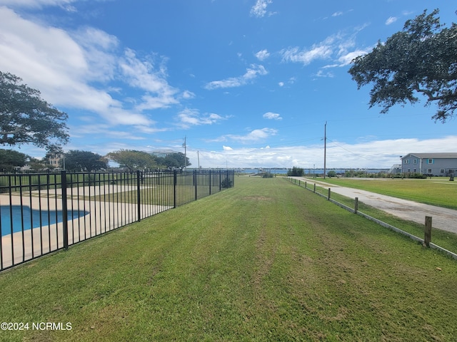 view of yard with a fenced in pool