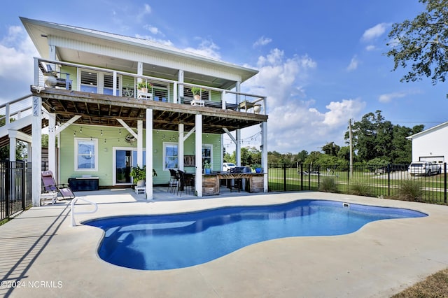 view of pool with exterior bar and a patio