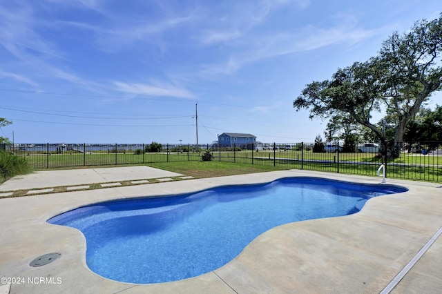 view of swimming pool featuring a yard and a patio