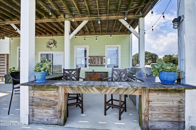 view of patio / terrace with a grill, area for grilling, and exterior bar