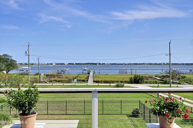 view of yard with a water view and a balcony