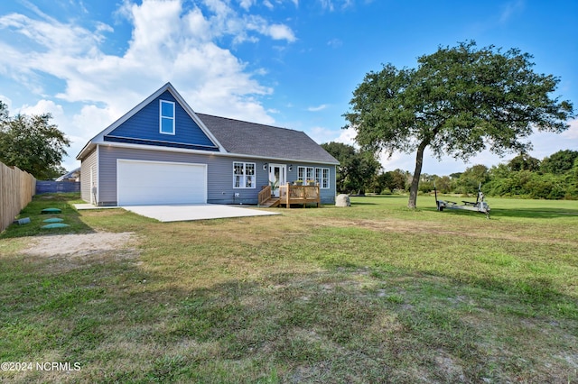 view of front of home featuring a front lawn, a deck, and a garage