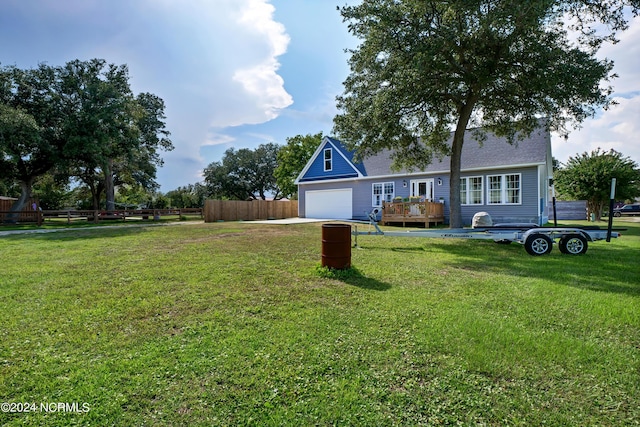 view of front of home with a front lawn, a garage, and a wooden deck