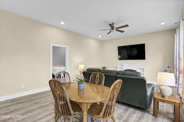 dining space with ceiling fan and hardwood / wood-style floors