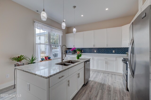 kitchen with stainless steel appliances, white cabinetry, and sink