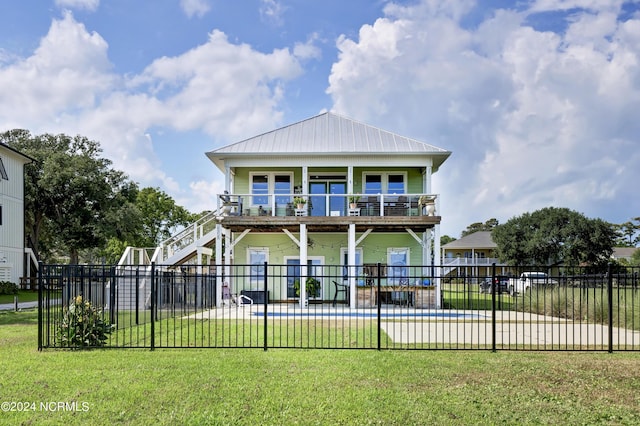 back of property featuring a swimming pool, a yard, and a patio