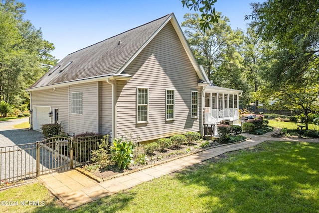 view of side of home with a yard