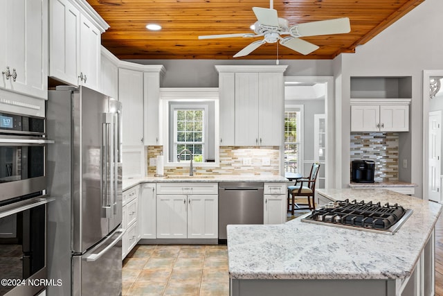 kitchen featuring white cabinets, wood ceiling, appliances with stainless steel finishes, and a sink