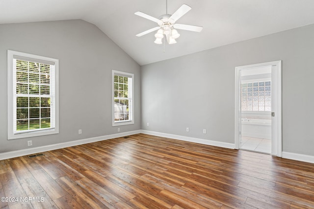 tiled spare room with vaulted ceiling and ceiling fan