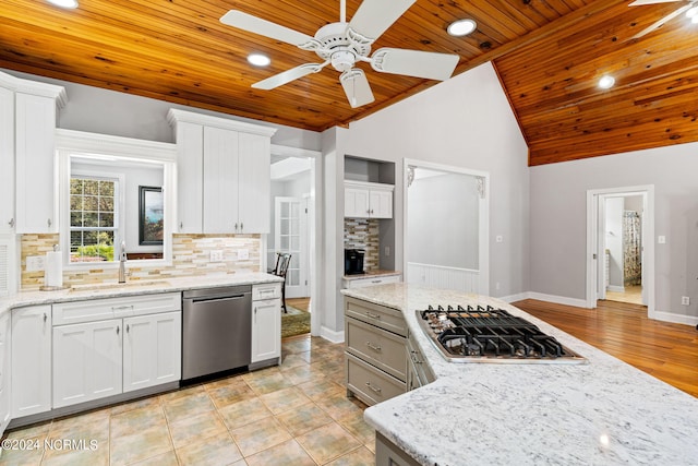 kitchen featuring a sink, white cabinets, light stone countertops, and stainless steel appliances