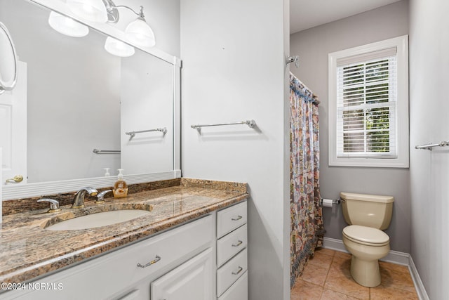 full bath featuring toilet, curtained shower, tile patterned flooring, baseboards, and vanity