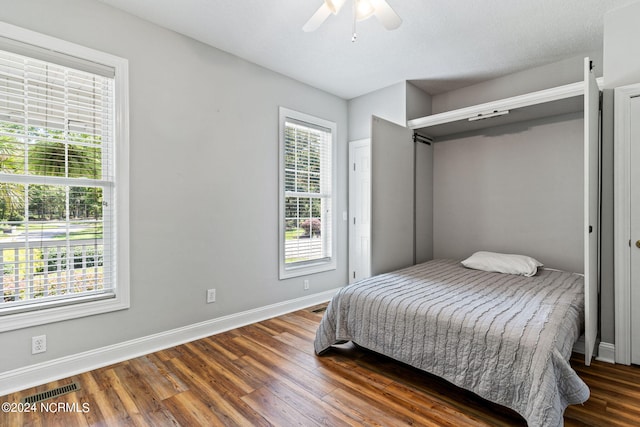 bedroom with dark wood-type flooring and ceiling fan