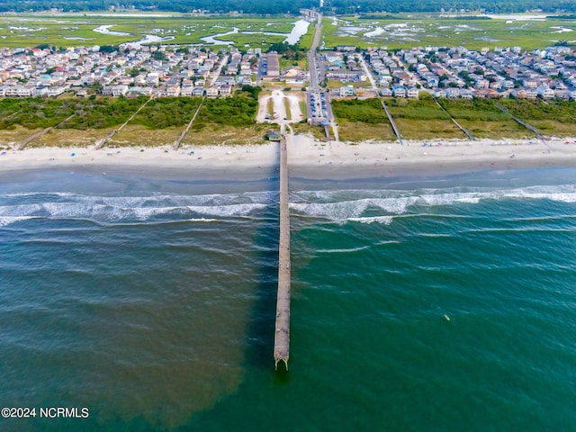 drone / aerial view with a view of the beach, a water view, and a residential view