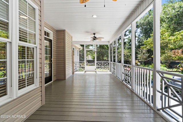 wooden deck featuring a ceiling fan