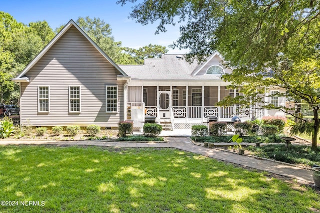 view of front facade featuring crawl space, a front lawn, and a sunroom