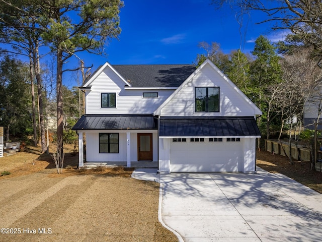 modern inspired farmhouse featuring a standing seam roof, metal roof, and concrete driveway