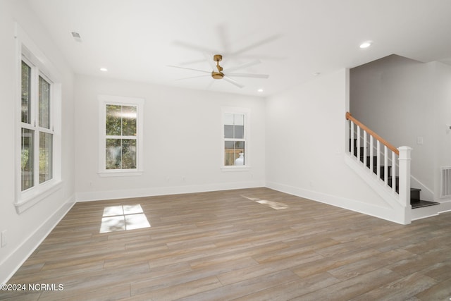 unfurnished living room with ceiling fan and light wood-type flooring