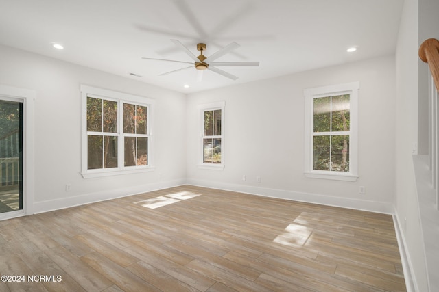 unfurnished room featuring ceiling fan, plenty of natural light, and light hardwood / wood-style floors