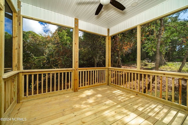 unfurnished sunroom with ceiling fan