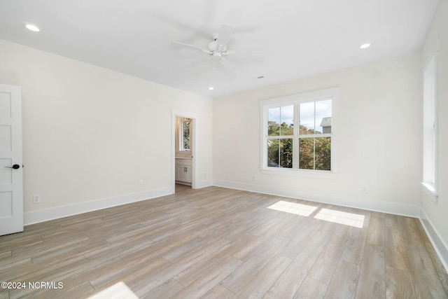 empty room featuring ceiling fan and light hardwood / wood-style floors