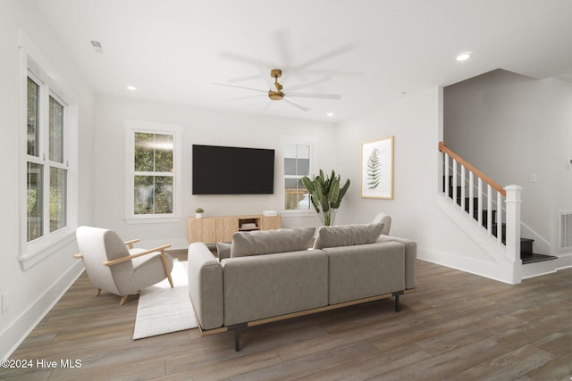 living room with dark wood-style floors, recessed lighting, baseboards, and stairs