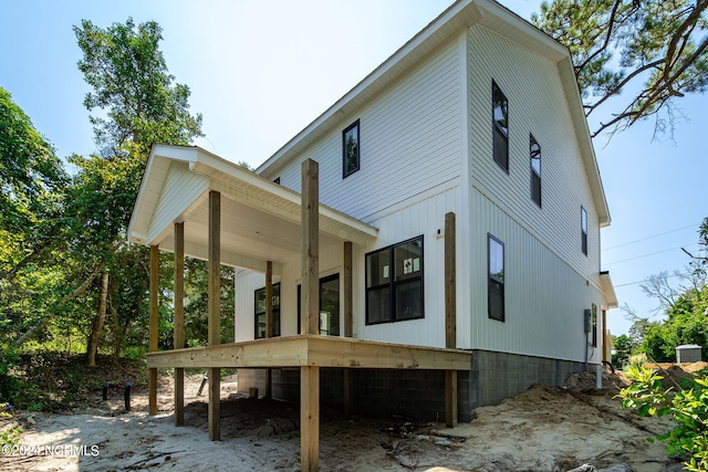 back of property featuring covered porch