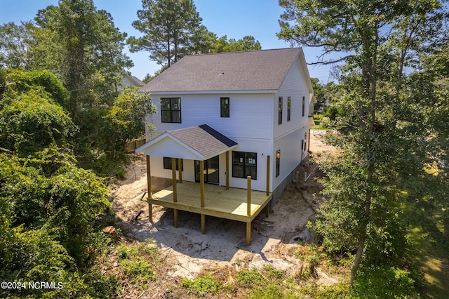 back of property featuring a wooden deck