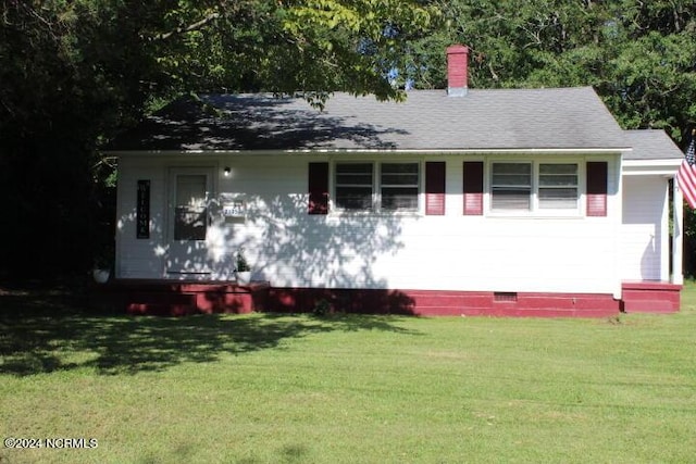 view of front of house featuring a chimney, roof with shingles, crawl space, and a front yard