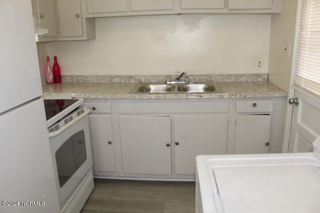 kitchen featuring sink, hardwood / wood-style floors, white appliances, and white cabinets